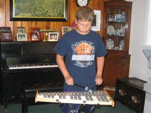 A student finding the instrument that most inspires him.